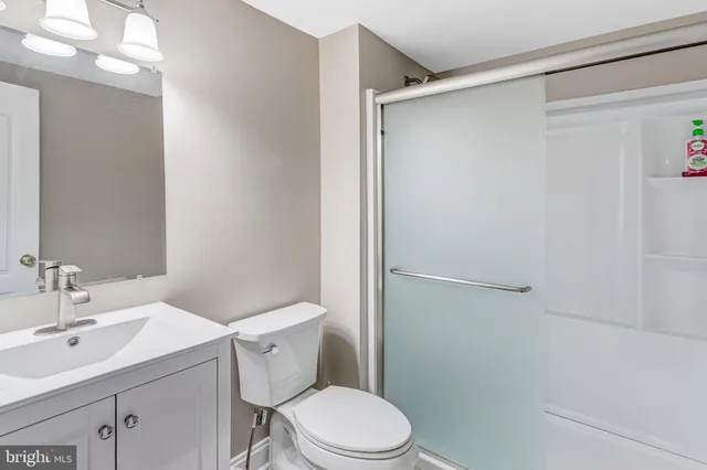 a white toilet sitting next to a bathroom sink