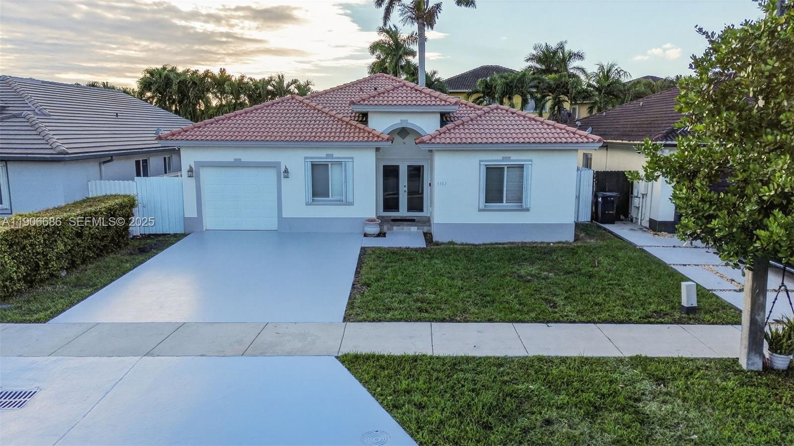 5302 Southwest 164th Place Miami, FL 33185 - Photo 1 of 43 a front view of a house with a garden