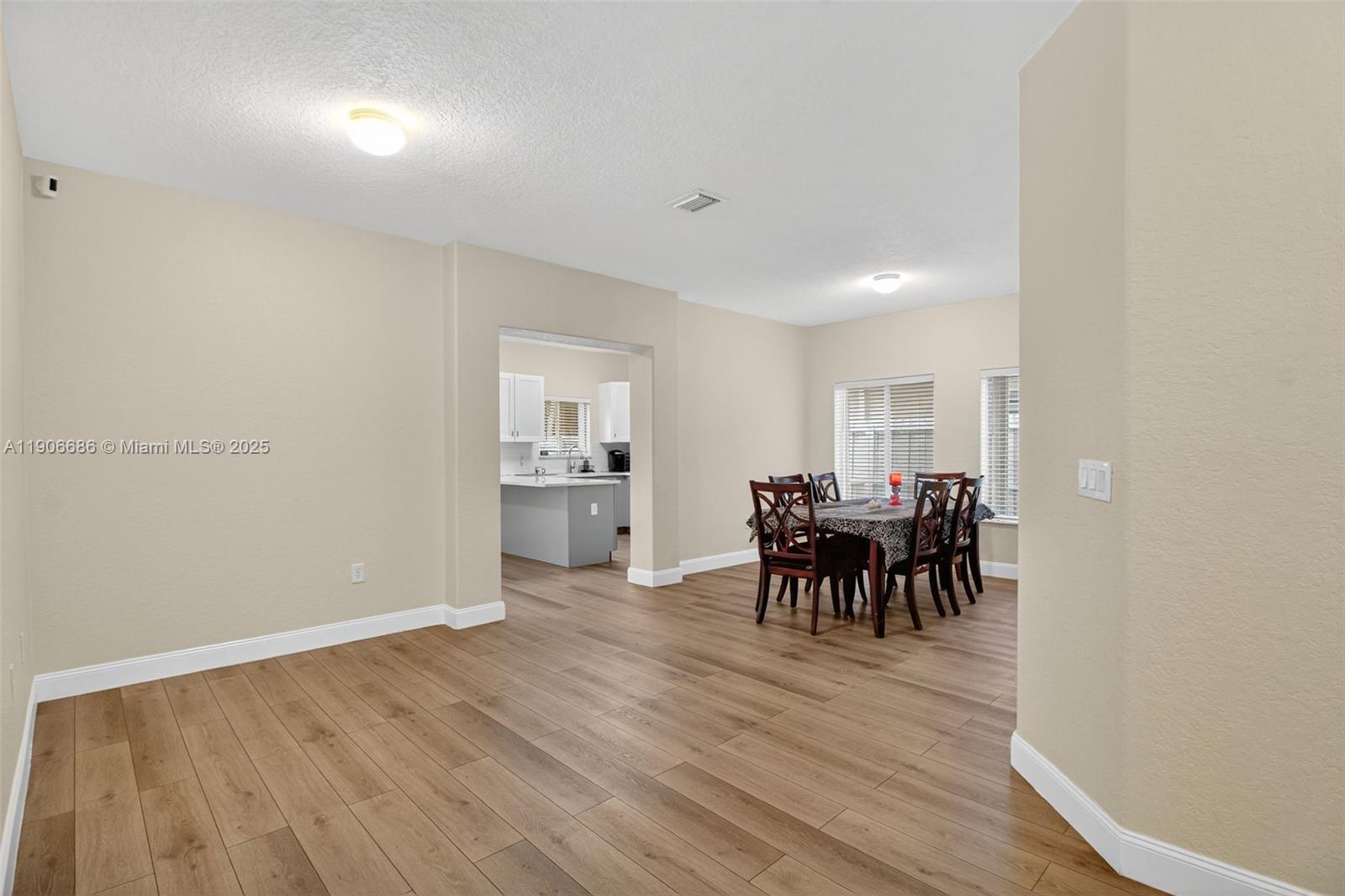 5302 Southwest 164th Place Miami, FL 33185 - Photo 12 of 43 a view of a dining room with furniture and chandelier