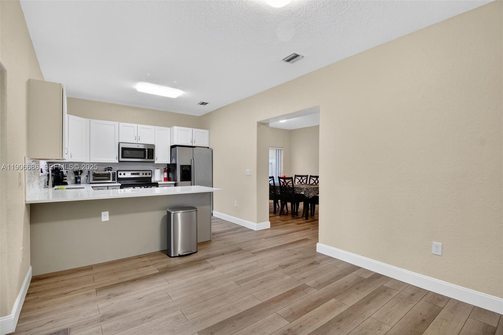 5302 Southwest 164th Place Miami, FL 33185 - Photo 16 of 43 a kitchen with stainless steel appliances granite countertop a stove a sink and a refrigerator