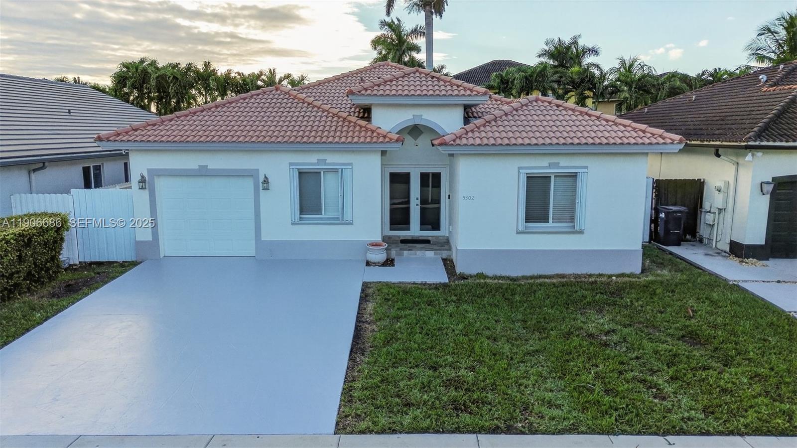 5302 Southwest 164th Place Miami, FL 33185 - Photo 2 of 43 a front view of a house with garden