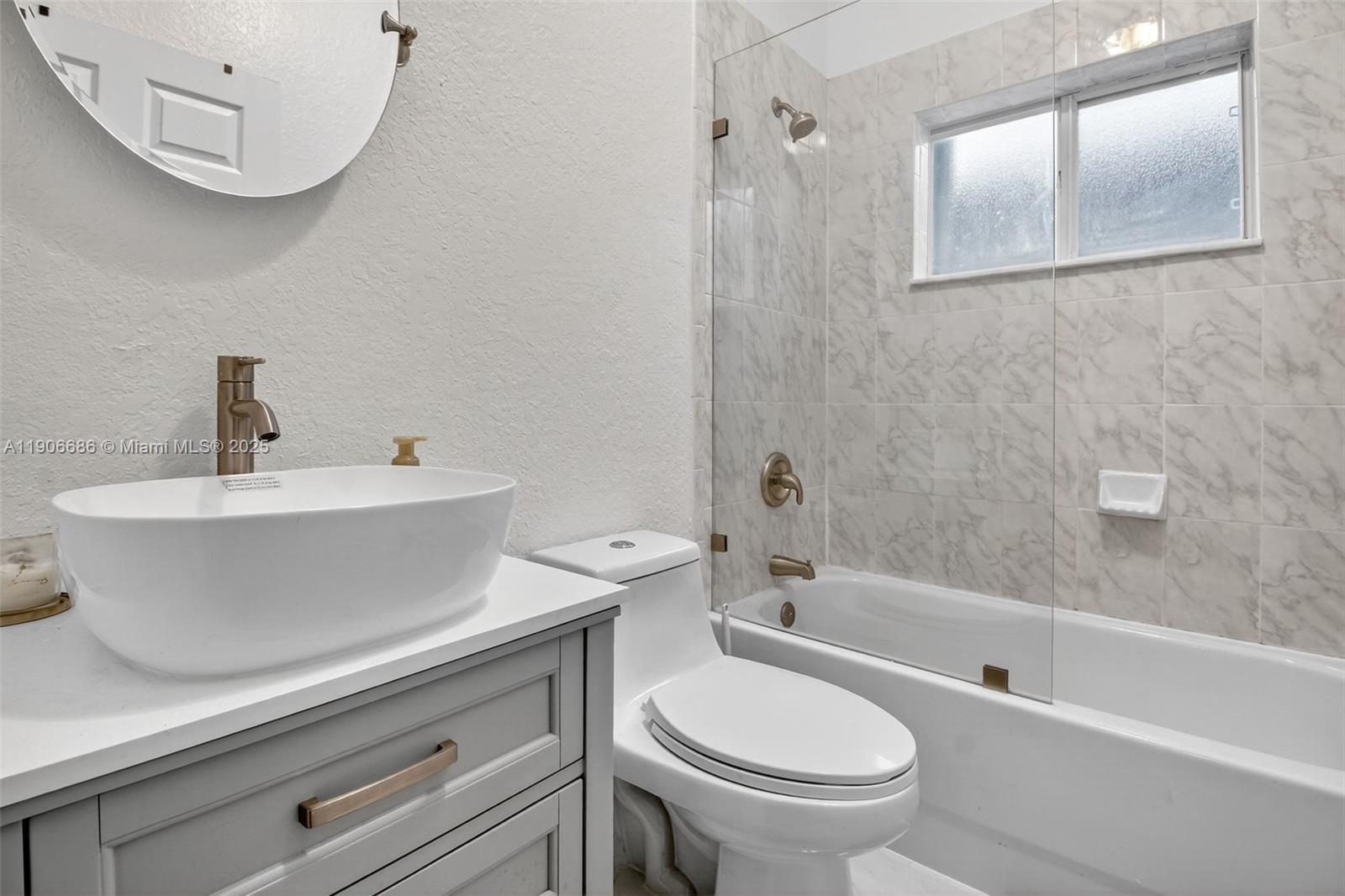 5302 Southwest 164th Place Miami, FL 33185 - Photo 22 of 43 a bathroom with a sink a toilet and a bathtub