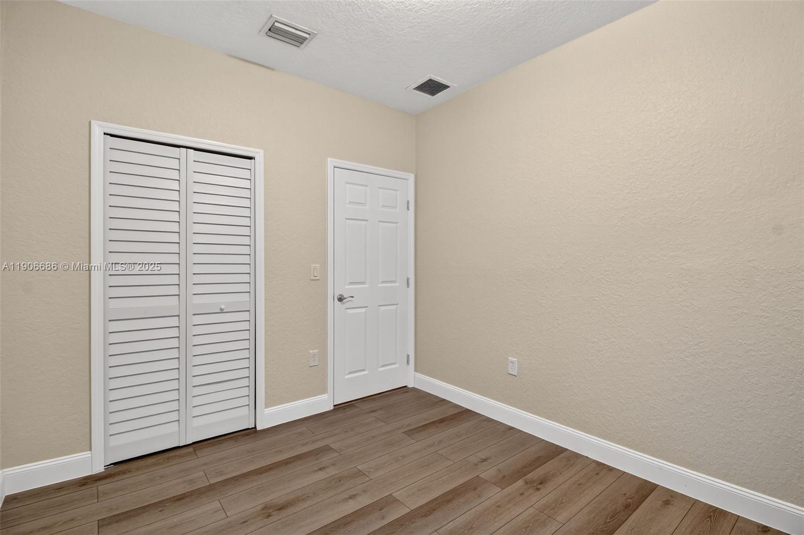 5302 Southwest 164th Place Miami, FL 33185 - Photo 25 of 43 a view of an empty room with closet and a window