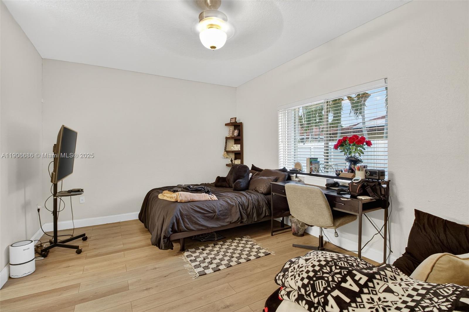 5302 Southwest 164th Place Miami, FL 33185 - Photo 31 of 43 a bedroom with furniture and a window