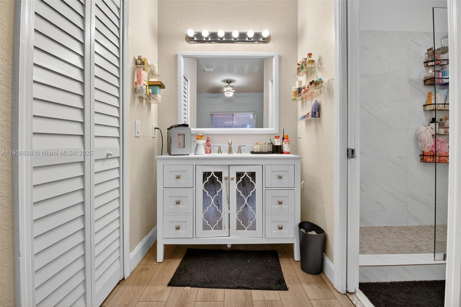 5302 Southwest 164th Place Miami, FL 33185 - Photo 33 of 43 a bathroom with a granite countertop sink a mirror and shower
