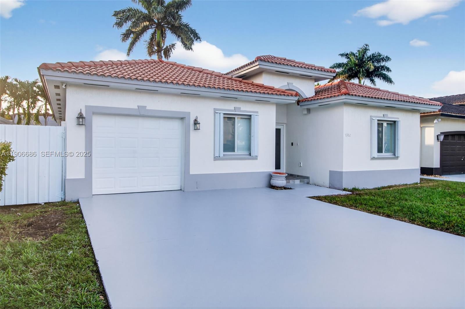 5302 Southwest 164th Place Miami, FL 33185 - Photo 4 of 43 a view of a house with a yard and garage