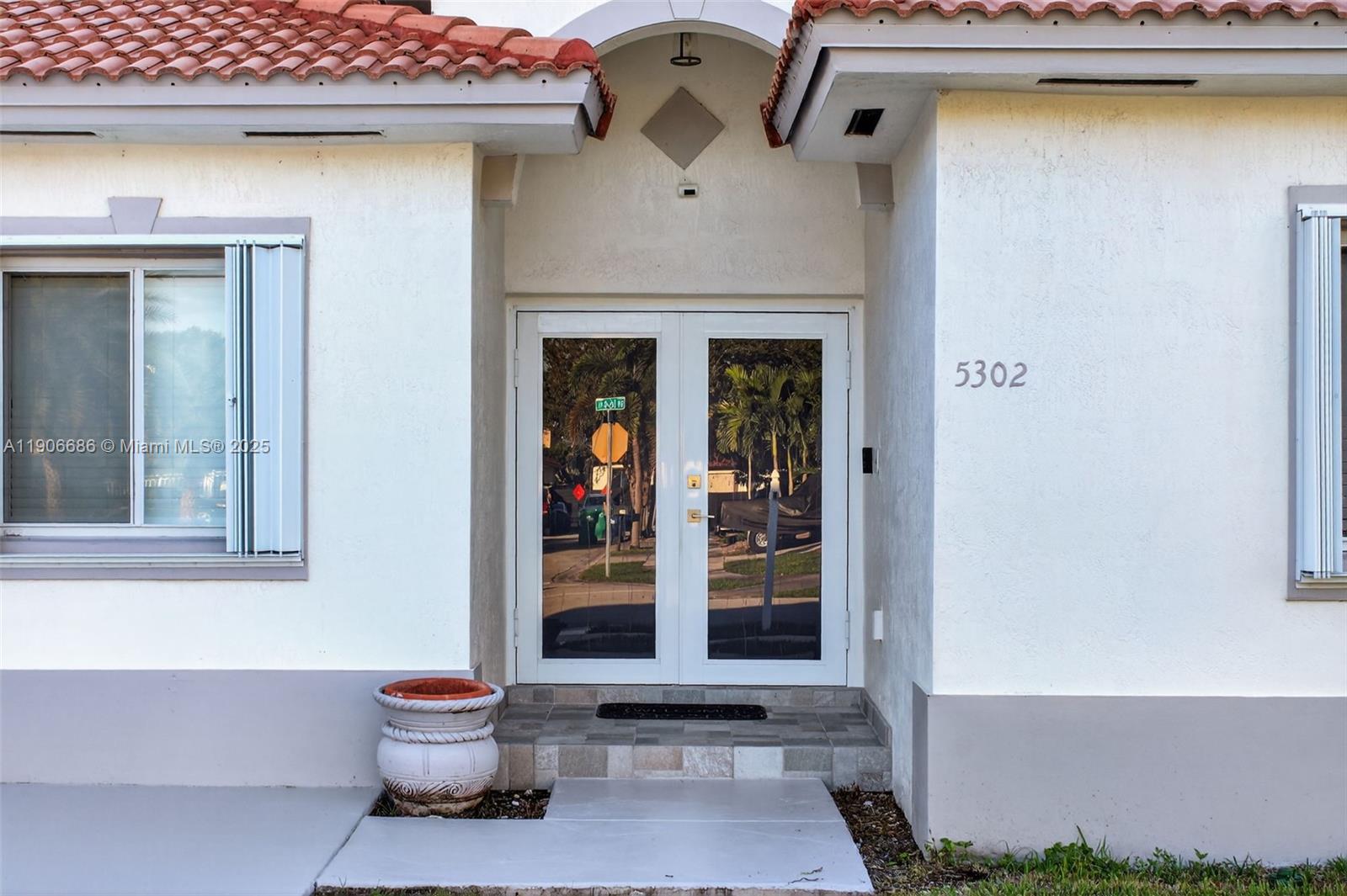 5302 Southwest 164th Place Miami, FL 33185 - Photo 6 of 43 a front view of a house with a yard