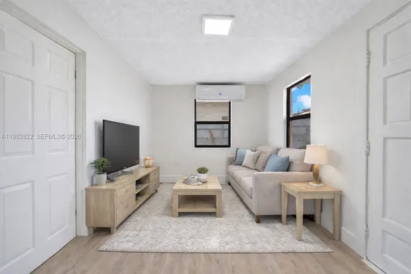 a living room with furniture and a flat screen tv