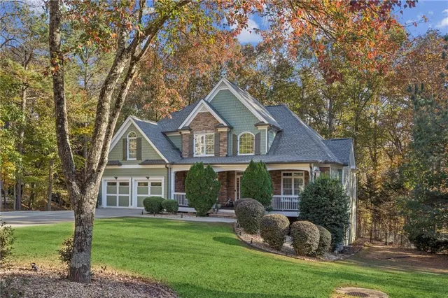 a front view of a house with a garden