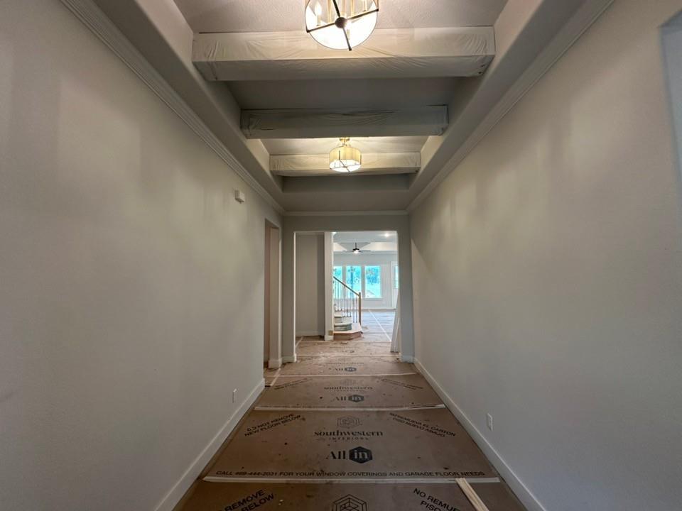 585 Brown Road Leonard, TX 75452 - Photo 4 of 29 Hallway featuring exposed ceiling beams, crown molding, baseboards, and overhead lighting fixtures