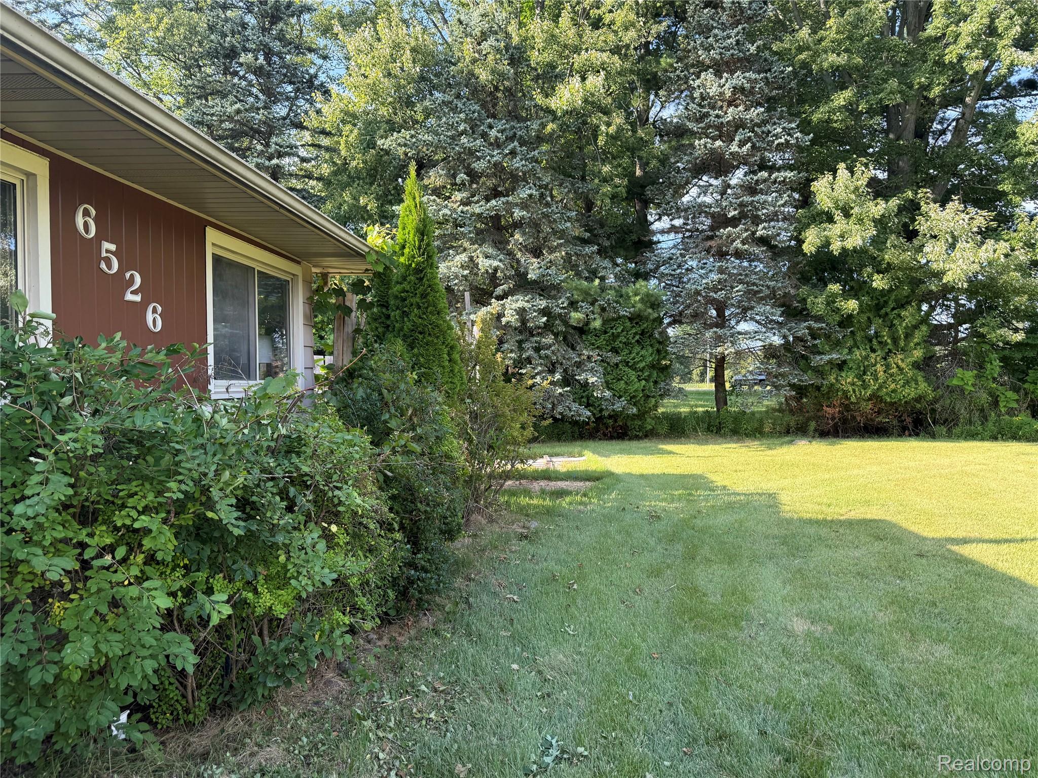 Manicured lawn with mature trees and established landscaping