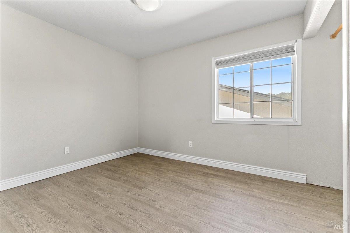4457 Graywhaler Lane Rohnert Park, CA 94928 - Photo 28 of 51 an empty room with wooden floor and windows
