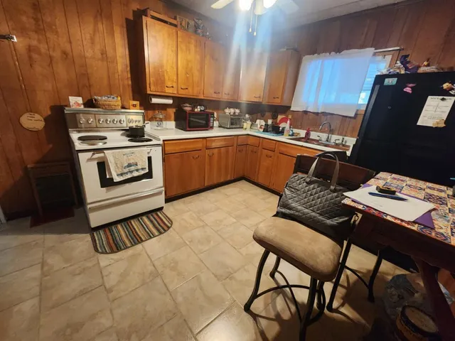 a kitchen with a stove a sink and a refrigerator