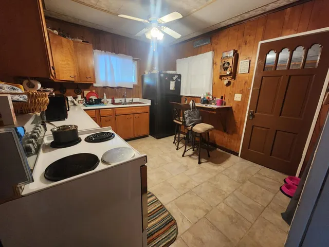 a kitchen with a sink a stove and a refrigerator