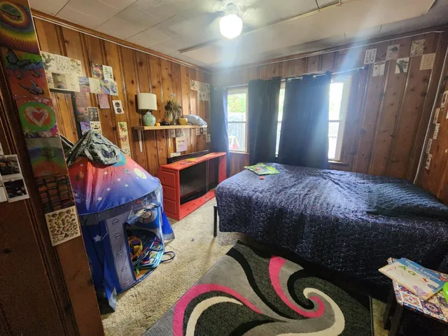 a bedroom with a bed and a mirror