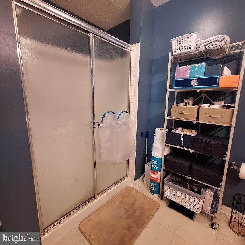 9609 Haven Farm Road, Unit 9609H Perry Hall, MD 21128 - Photo 13 of 21 Modern shower space with organized storage.
