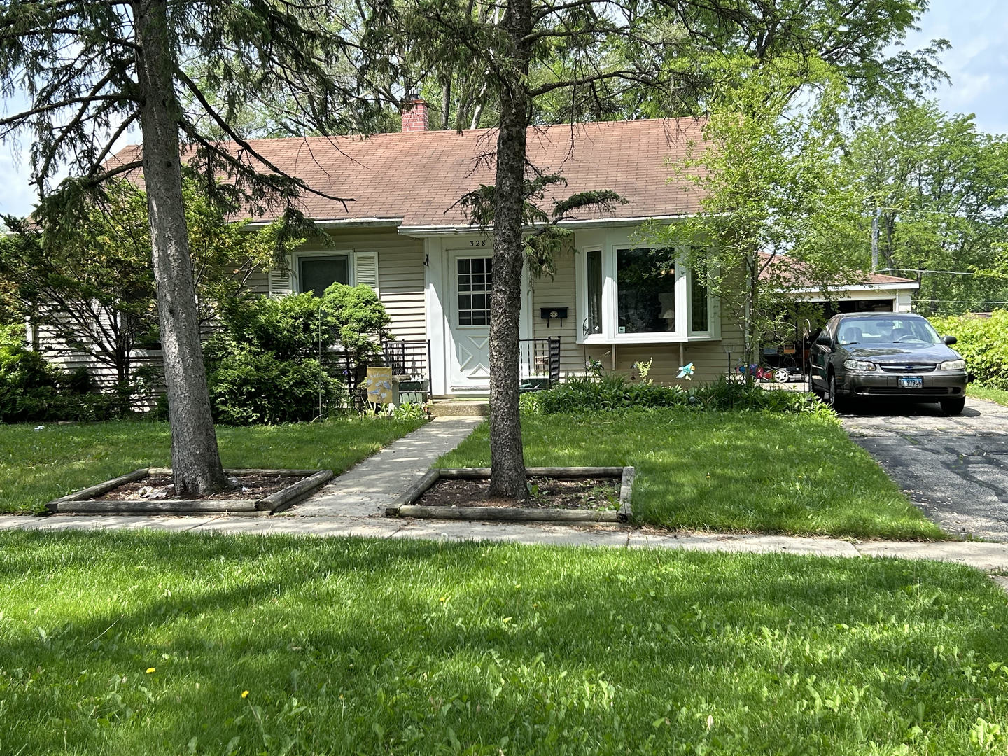 328 Raupp Boulevard Buffalo Grove, IL 60089 - Photo 2 of 22 a front view of a house with a yard and porch