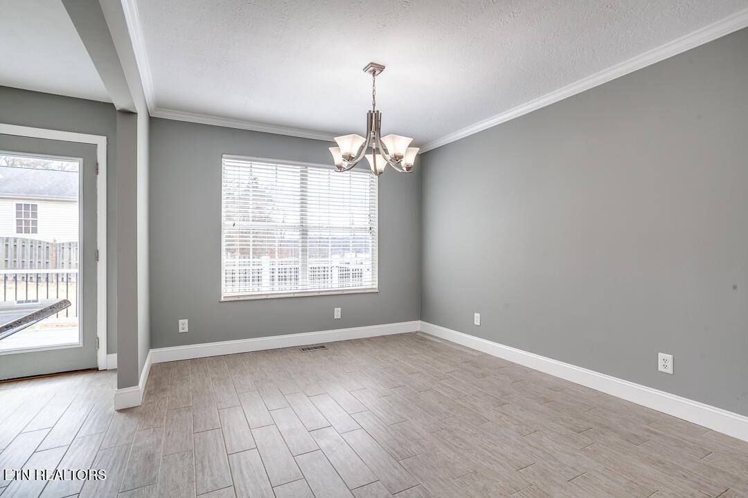1296 Emerald Forest Lane Powell, TN 37849 - Photo 11 of 43 a view of a livingroom with wooden floor and a large window