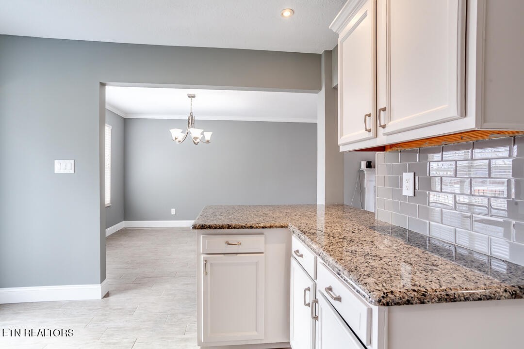 1296 Emerald Forest Lane Powell, TN 37849 - Photo 20 of 43 a kitchen with granite countertop a sink and cabinets