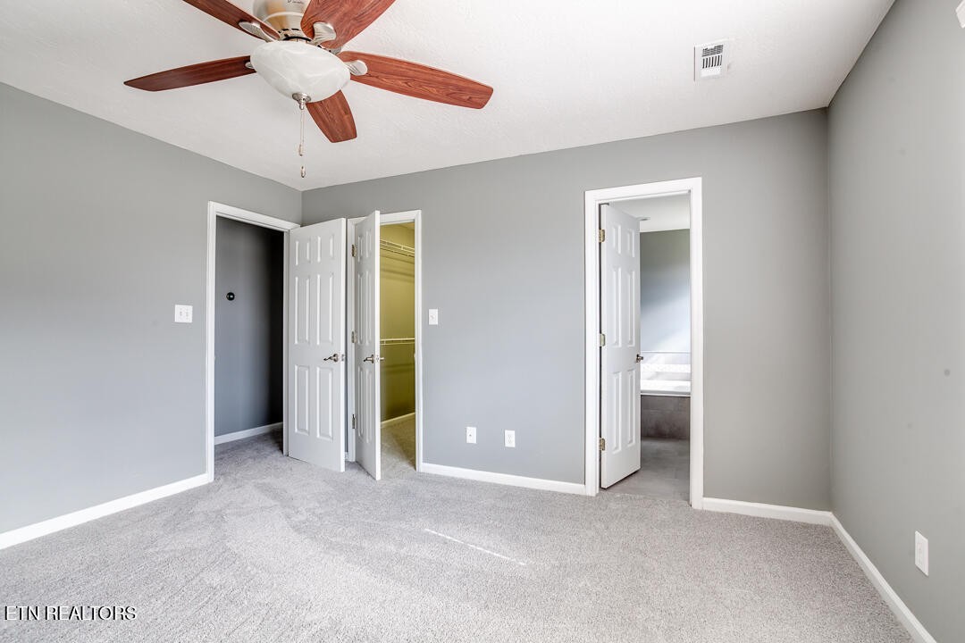 1296 Emerald Forest Lane Powell, TN 37849 - Photo 23 of 43 an empty room with closet and a ceiling fan