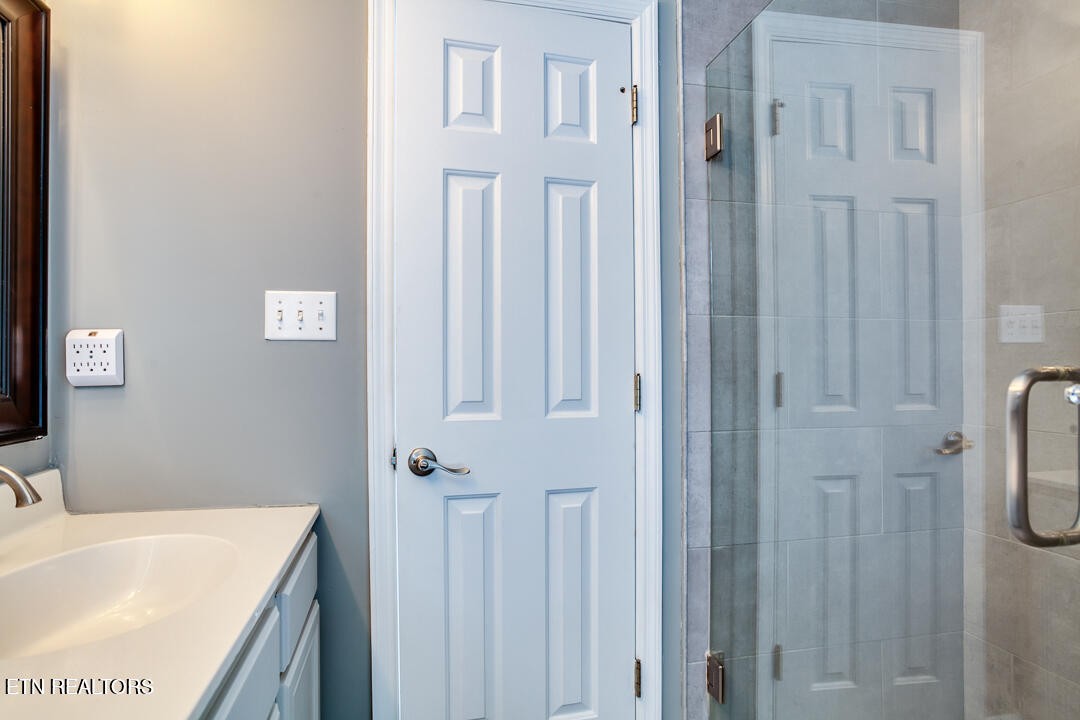 1296 Emerald Forest Lane Powell, TN 37849 - Photo 25 of 43 a bathroom with a tub sink vanity and granite