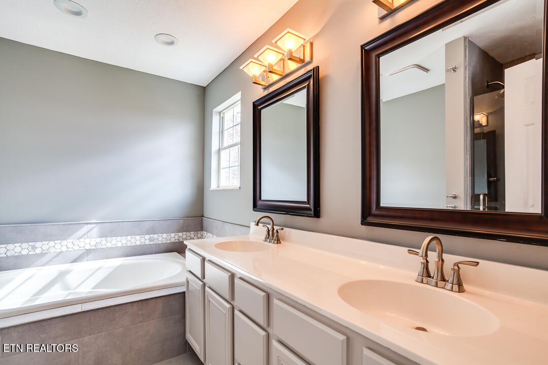 1296 Emerald Forest Lane Powell, TN 37849 - Photo 26 of 43 a bathroom with 2 sink and a large mirror