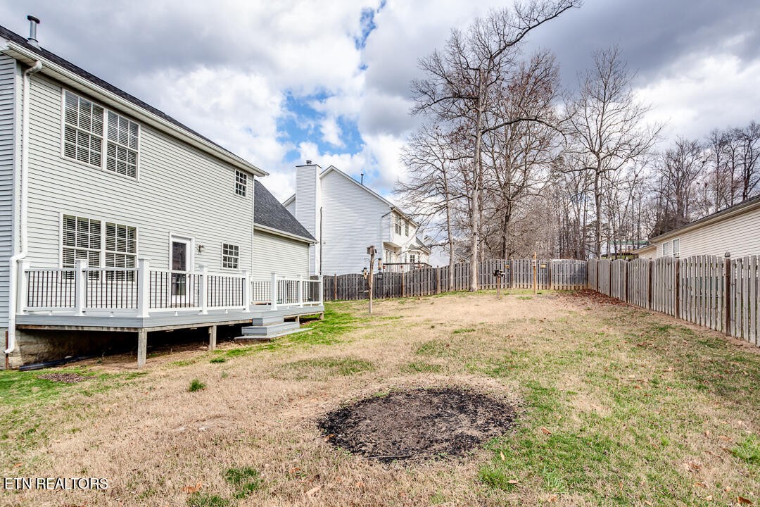 1296 Emerald Forest Lane Powell, TN 37849 - Photo 41 of 43 a backyard of a house with large trees and wooden fence