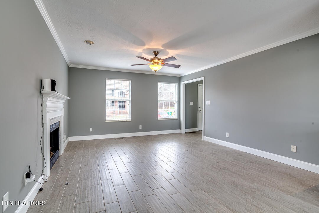 1296 Emerald Forest Lane Powell, TN 37849 - Photo 5 of 43 a view of an empty room with a window and wooden floor