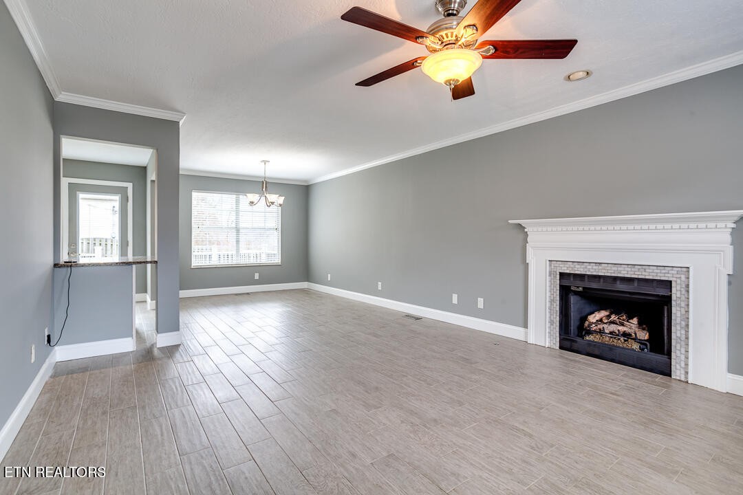 1296 Emerald Forest Lane Powell, TN 37849 - Photo 8 of 43 an empty room with windows and fireplace