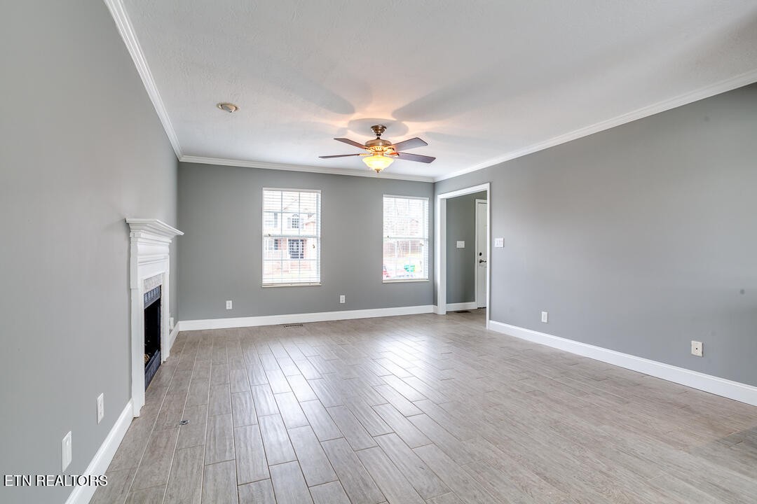 1296 Emerald Forest Lane Powell, TN 37849 - Photo 9 of 43 a view of an empty room with a window and wooden floor