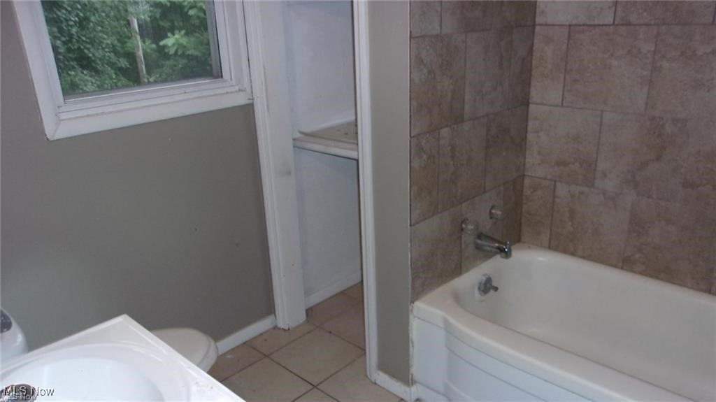 863 West Prospect Road Ashtabula, OH 44004 - Photo 9 of 9 Bathroom with light tile patterned flooring, shower / tub combination, and vanity