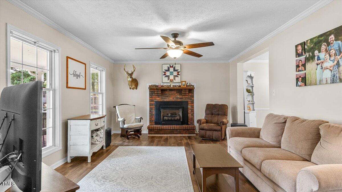 1401 Berea Road Rougemont, NC 27572 - Photo 10 of 65 a living room with furniture a fireplace and a flat screen tv