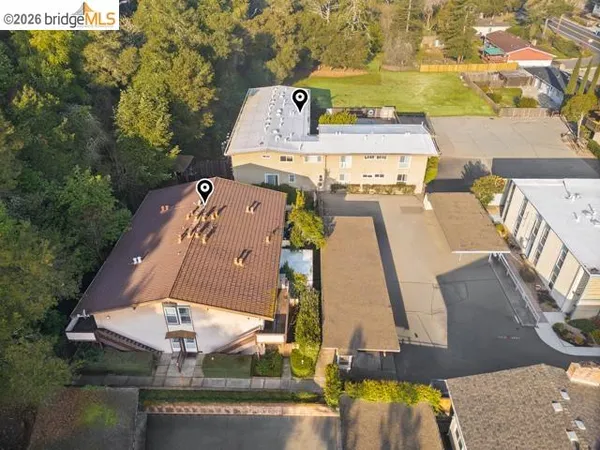 an aerial view of a house with outdoor space swimming pool