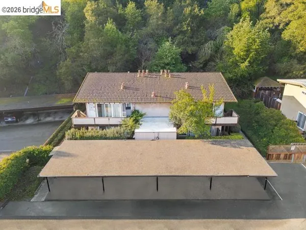 an aerial view of a house with yard swimming pool and outdoor seating