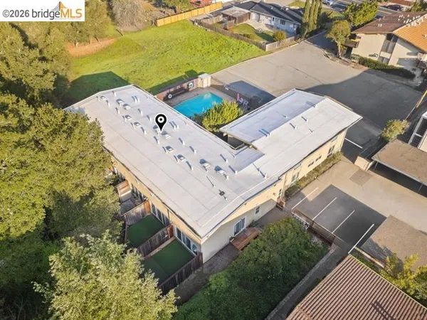 an aerial view of residential houses with outdoor space