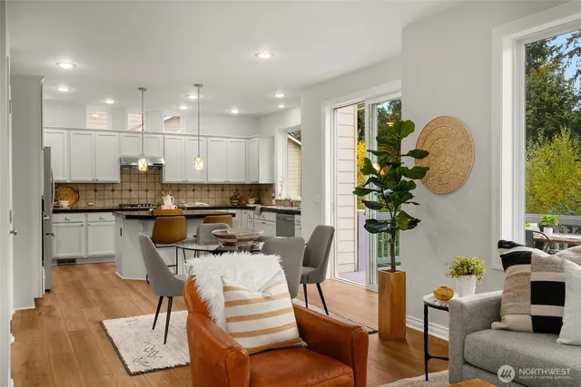 a dining room filled chandelier and kitchen view