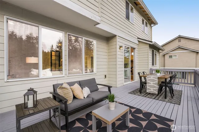 a view of a dining table and chairs on the roof deck