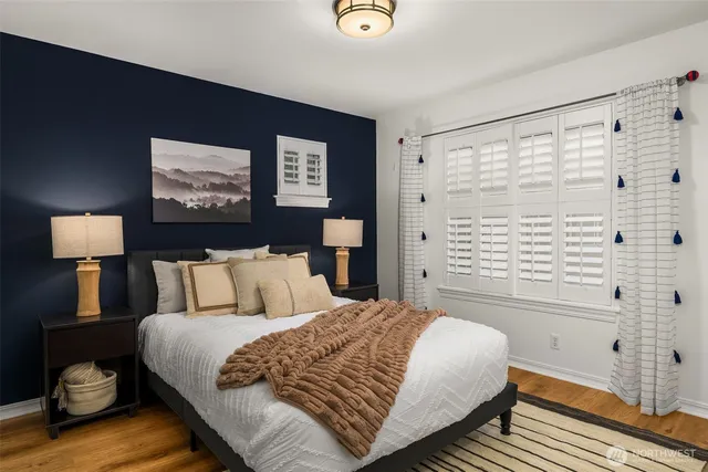 a bed room with a bed and a potted plant