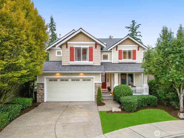a front view of a house with a yard and green space