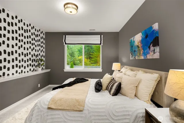 a bathroom with a granite countertop sink mirror vanity and toilet