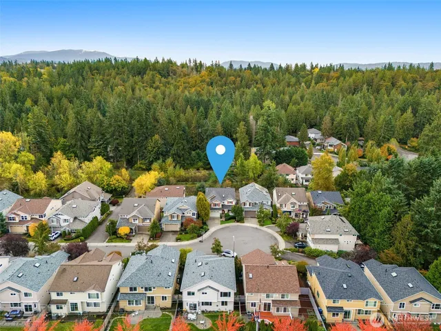 an aerial view of a house with a swimming pool outdoor seating and yard