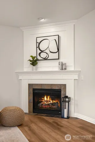 a living room with a fireplace a sink and a potted plant