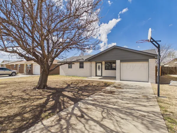a big house with tree in front of it