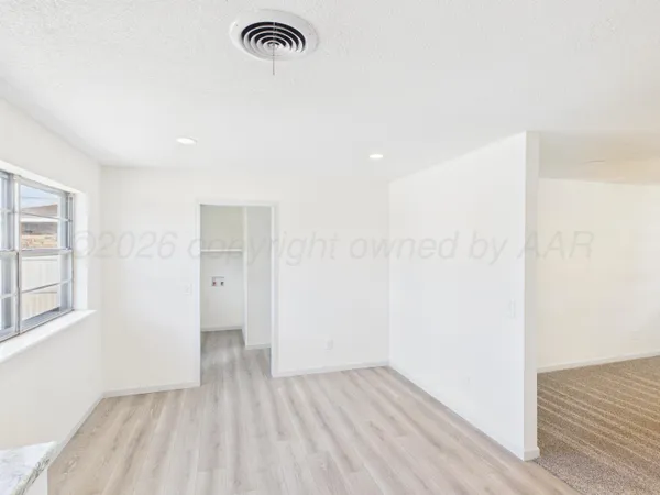 a view of a room with wooden floor