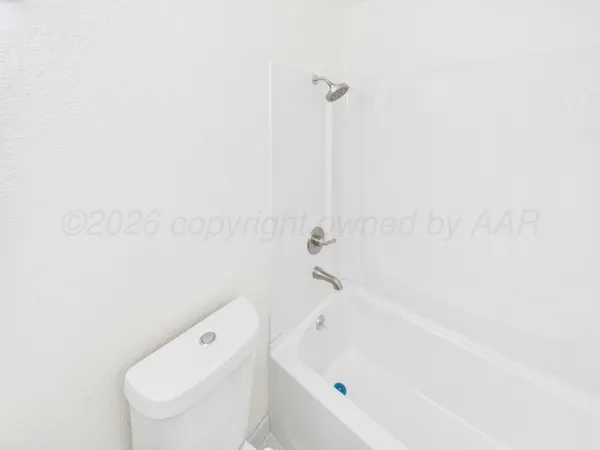 a bathroom with a bathtub and toilet