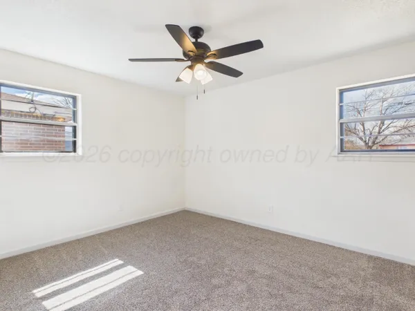 a view of room with window and ceiling fan