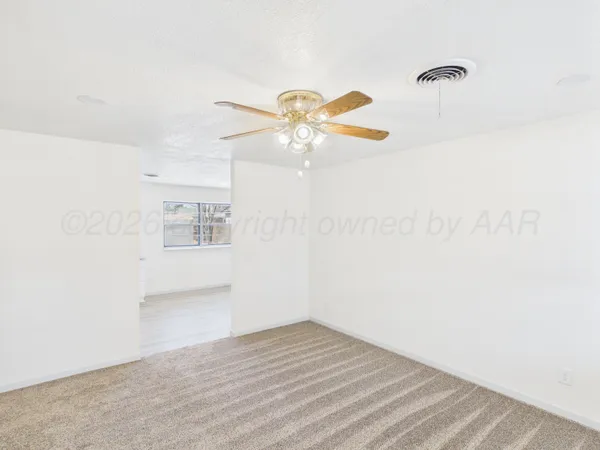 a view of a room with a kitchen and a window