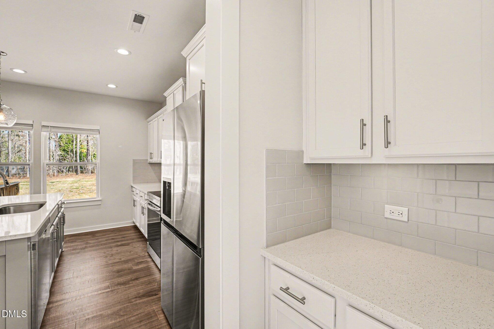 51 East Dentaires Way Willow Spring, NC 27592 - Photo 11 of 39 a kitchen with cabinets and wooden floor