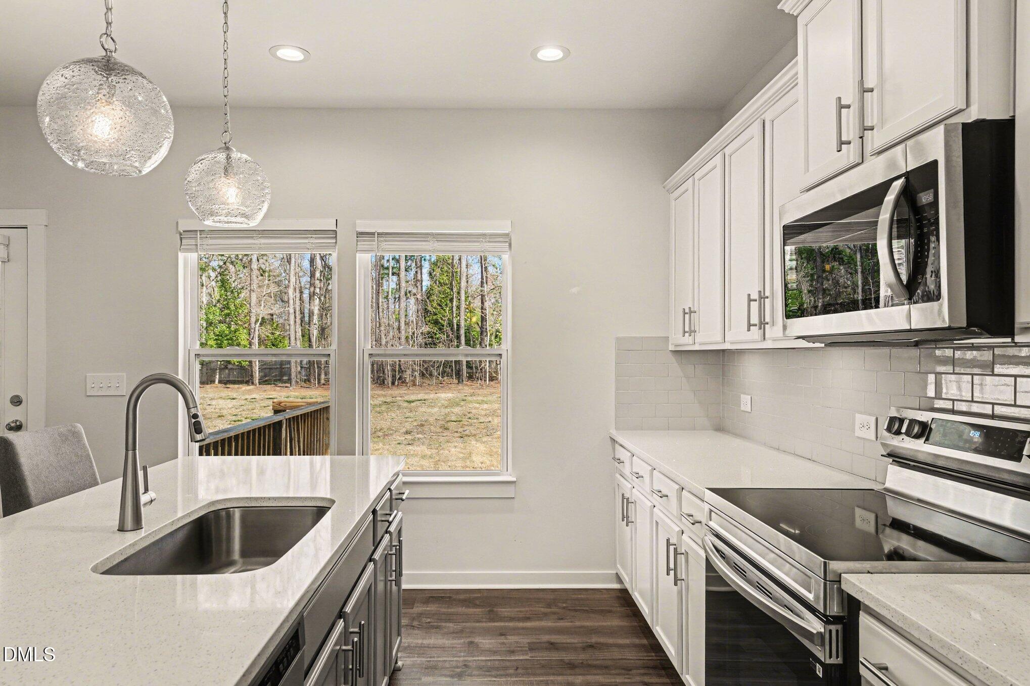 51 East Dentaires Way Willow Spring, NC 27592 - Photo 16 of 39 a kitchen that has a sink and a stove