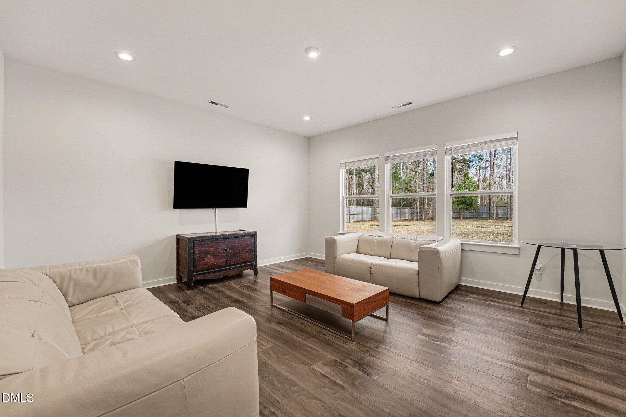 51 East Dentaires Way Willow Spring, NC 27592 - Photo 17 of 39 a living room with furniture and a flat screen tv